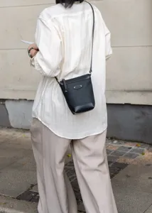 Stylish black leather crossbody phone bag for women, premium minimalist commuter shoulder bag.