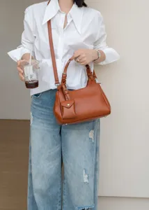 Elegant genuine leather crossbody handbag with small pendant, premium casual shoulder bag for women.