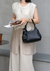 Detailed showcase of the premium genuine leather shoulder bag featuring a stylish mini strap pouch.