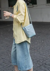 Leather crossbody bag for women, stylish light blue bucket bag with top grain cowhide.