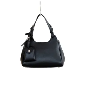 Elegant black leather shoulder bag with chic hanging pouch and silver hardware for women.