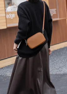 Brown leather crossbody bag with zipper, compact shoulder bag for women daily wear details.