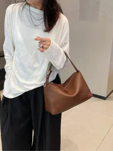 Brown genuine leather shoulder bag for women, stylish crossbody pillow bag with top zip.