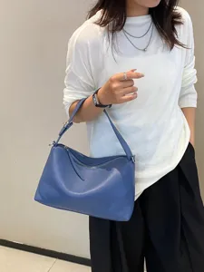 Blue leather shoulder bag for women, stylish hobo purse with zipper and comfortable strap.