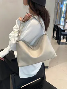 Natural tumbled cowhide underarm shoulder bag, stylish minimalist crescent pillow bag for women.