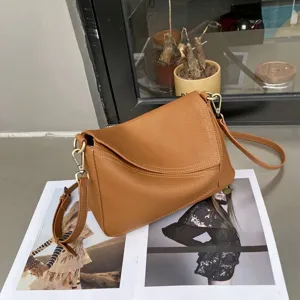 Brown genuine leather shoulder bag for women, stylish geometric crossbody bag with adjustable strap.