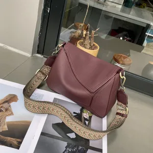 Detailed view of women's genuine leather shoulder bag featuring unique geometric design and strap.