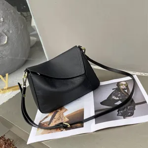 Black genuine leather shoulder bag for women, stylish geometric pillow crossbody bag with strap.
