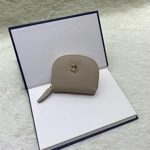 Mini leather coin purse card holder with elegant metal flower detail for women daily use.