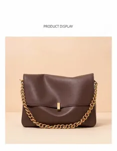 Detailed view of women's brown leather shoulder bag with chunky gold chain and lock.