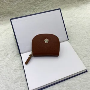 Leather mini coin purse detail view, showing the premium texture and flower metallic decor.