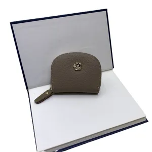 Genuine leather mini coin purse for women, compact card holder with cute flower hardware.