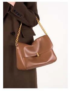Brown leather shoulder bag detail, elegant chain strap and metal clasp for women commute.