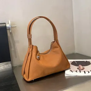 Genuine leather shoulder bag for women, stylish brown hobo tote with top handle and spacious design.