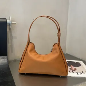 Genuine leather brown shoulder bag for women, stylish underarm hobo bag with large capacity.