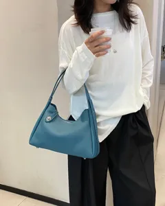 Blue leather shoulder bag for women, stylish underarm hobo bag with top grain cowhide.