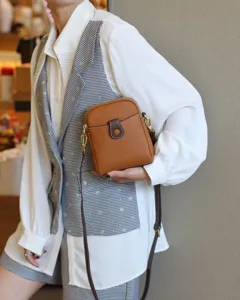 Detailed view of the stylish brown leather mini crossbody bag, perfect for daily use and phones.