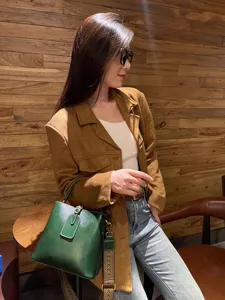 Retro genuine leather bucket bag with wide strap, elegant green crossbody handbag for daily use.