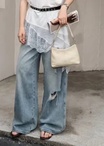 Detailed view of the minimalist beige genuine leather shoulder bag for women daily commuting.