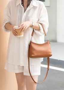 Brown genuine leather shoulder bag for women, elegant hobo crossbody bag with adjustable strap.