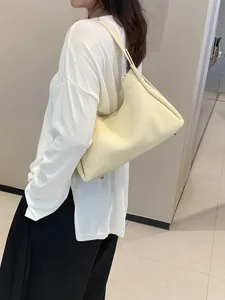 Genuine leather underarm shoulder bag for women, elegant beige hobo handbag for daily use.