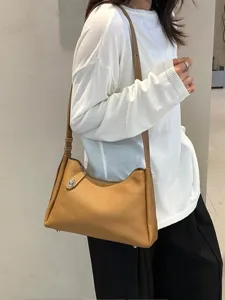 Stylish genuine leather shoulder bag for women, classic brown hobo bag with elegant metal clasp.