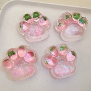 Pink cat paw squishy stress relief toy with cute glitter jelly design for fun relaxation.