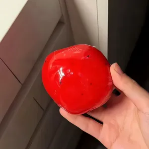 Red squishy stress relief toy hand squeeze fidget toy cute decompression ball for adults and kids.
