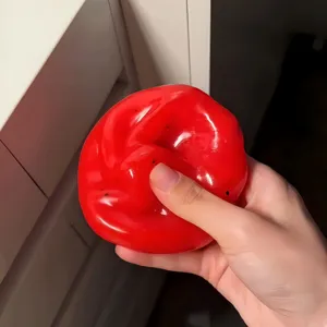 Red squishy stress relief toy, glossy soft gel ball for sensory tactile fun and anxiety relief.