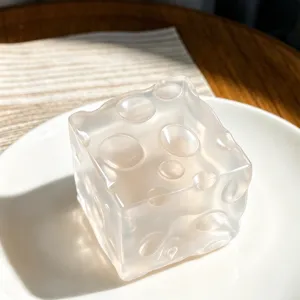 Transparent cheese squishy toy detail, soft silicone stress relief cube for tactile fun.