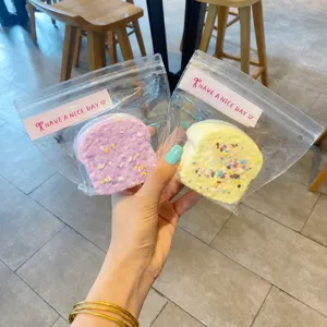 Close-up of cute toast squishy decompression toys in transparent ziplock bags with colorful sprinkles.