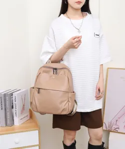 Detailed view of women genuine leather backpack showcasing soft cowhide texture and smooth zippers.