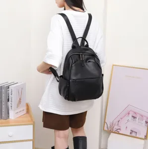 Black genuine leather backpack for women, stylish and lightweight travel daypack.
