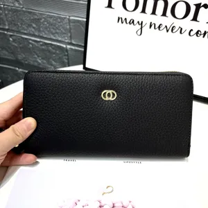 Black leather long wallet detail showing texture, metal ring buckle, and card slots design.