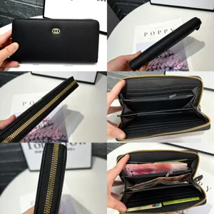 Black leather long wallet detail view showing multi-card slots, durable gold zipper and large capacity.
