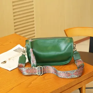 Green leather shoulder bag detail, vintage pillow bag with wide ethnic strap for women.