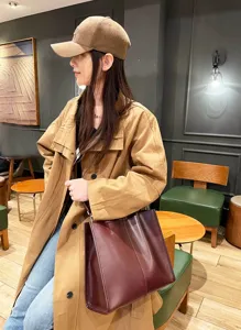 Wine red leather tote bag detail, genuine cowhide single shoulder crossbody bag for women.