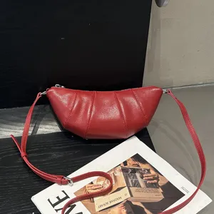 Red leather croissant shoulder bag, chic pleated crossbody bag for women daily commute.