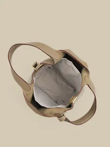 Classic genuine leather bucket handbag viewed from top with interior lining for women.