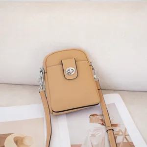 Compact genuine leather crossbody phone bag in tan with stylish turn-lock closure and strap.