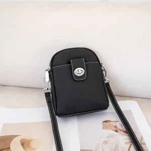 Genuine leather black vertical phone bag, detail view showcasing quality hardware and fine stitching.