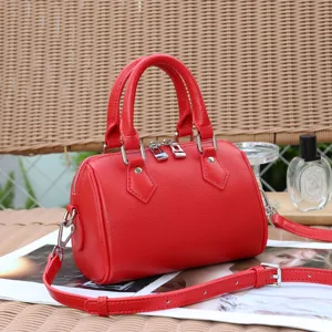 Red genuine leather Boston shoulder bag detail view with metallic zippers and top handles.