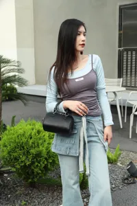 Genuine leather Boston bag for women, classic black shoulder handbag with metal hardware.