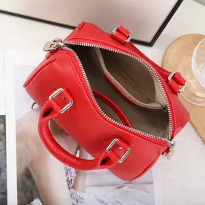 Red leather Boston bag interior detail, top grain cowhide pillow handbag for women.