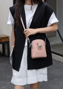 Pink leather vertical cell phone bag for women, stylish crossbody shoulder bag with turn-lock.