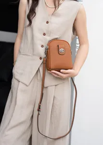 Brown leather vertical crossbody phone bag with stylish turn-lock closure and slim strap.