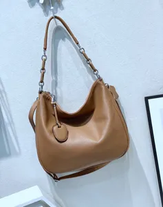 Brown genuine leather hobo shoulder bag detail, slouchy design with stylish metal chain strap.
