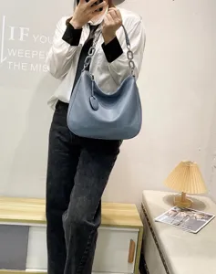 Detailed view of soft leather hobo shoulder bag with stylish chain strap and casual drape.