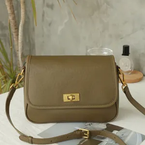 Olive green leather retro crossbody bag detail, vintage metal lock and adjustable strap.