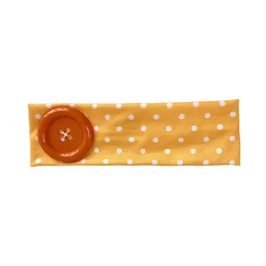 Summer dopamine yellow polka dot headband with large orange button, chic elastic hair accessory.